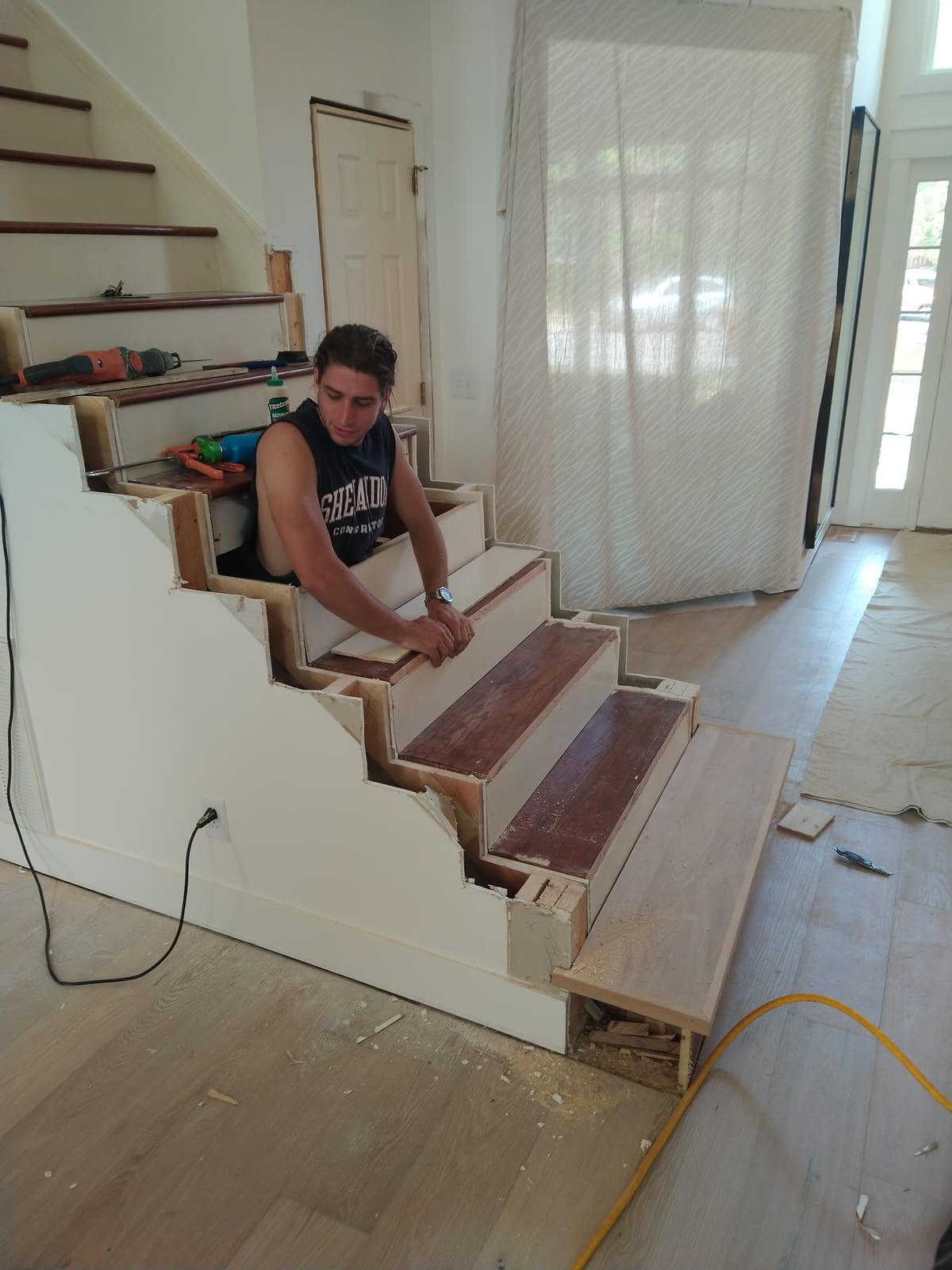 A finished staircase with custom wood treads and railings